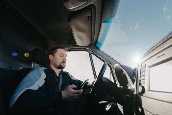 Pittsburgh driver takes his eyes off the road to look at his cell phone. 