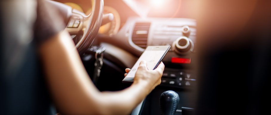 Distracted driver looks at phone while driving