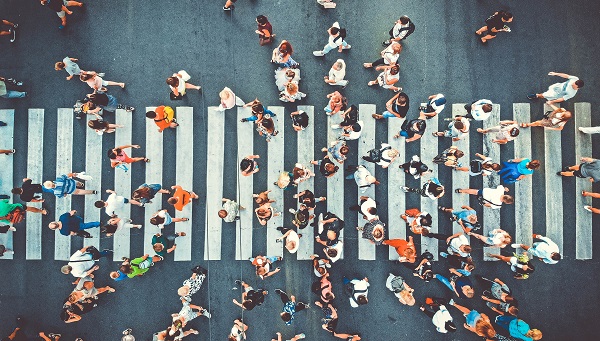 Aerial. People crowd on pedestrian crosswalk in Pittsburgh, PA.