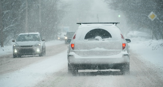 Two vehicles passing each other on a snowy street