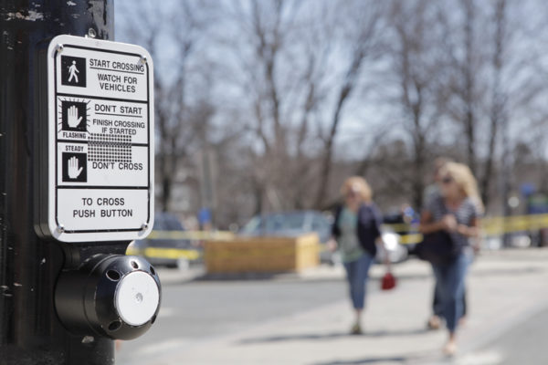 Close-up of crosswalk signage and button